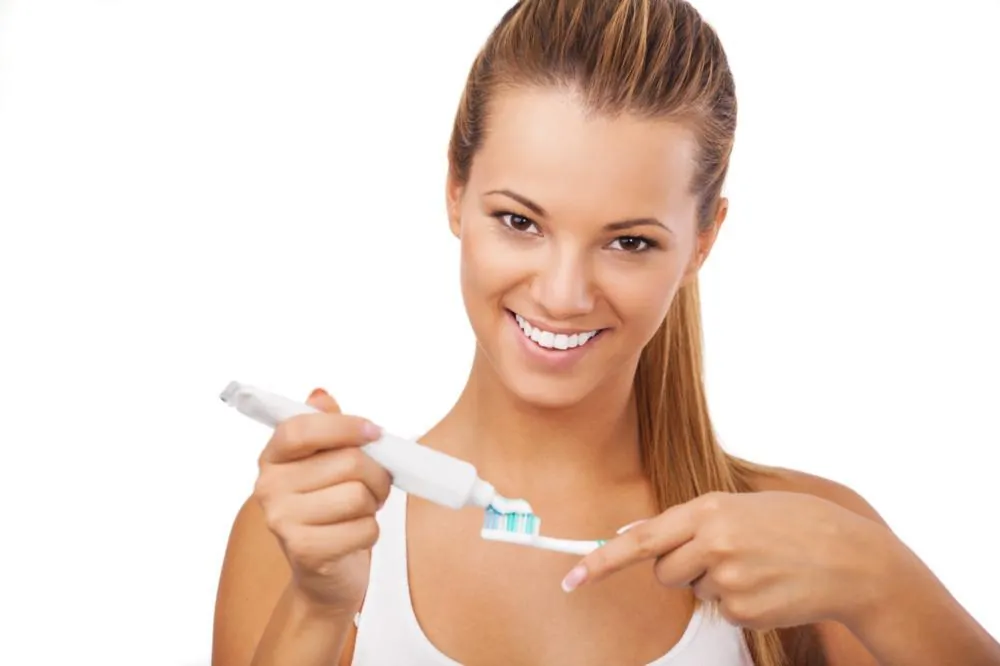 Smiling woman holding a toothbrush