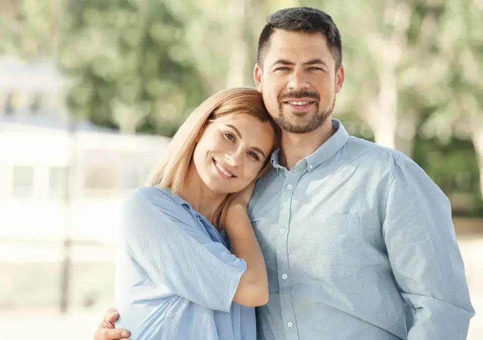 Happy couple embracing outdoors