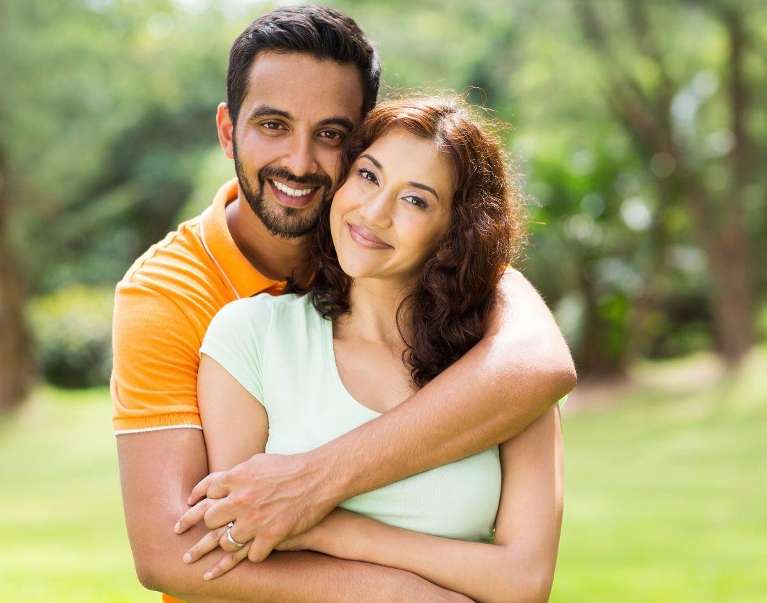 A couple smiling after Dental Bridge in Elk Grove Village
