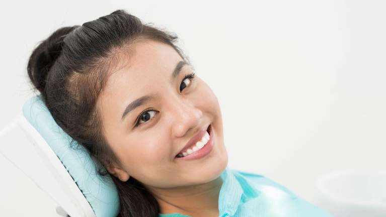Patient smiling after dental bridge fillings at Elk Grove Smile Center