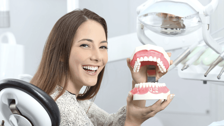 A dentist with a dental model in Elk Grove Village, IL
