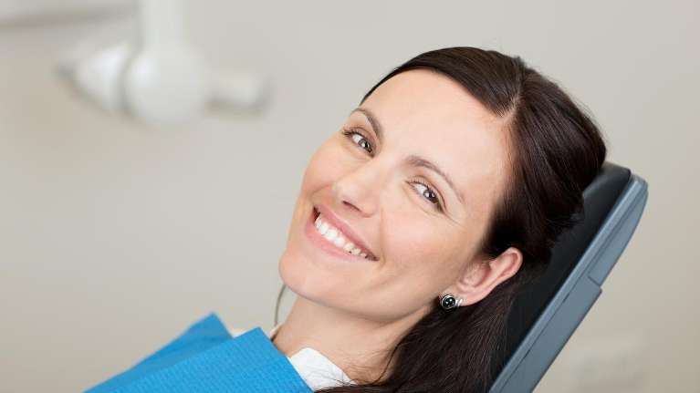 Lady relaxing after tooth extraction at Elk Grove Smile Center