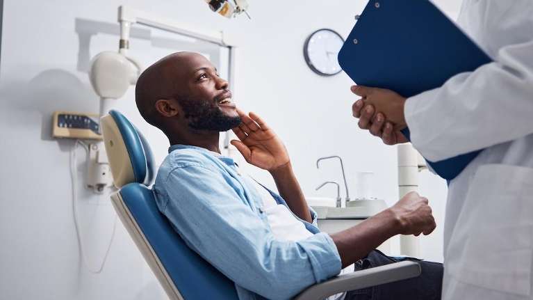 A black man getting a dental advise on Wisdom Tooth Removal and Extractions in Elk Grove Village, IL