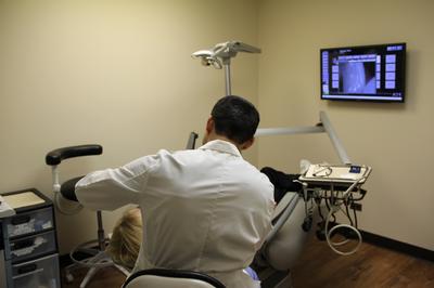 Dr. Vishal with a patient in exam room at Elk Grove Smile Center